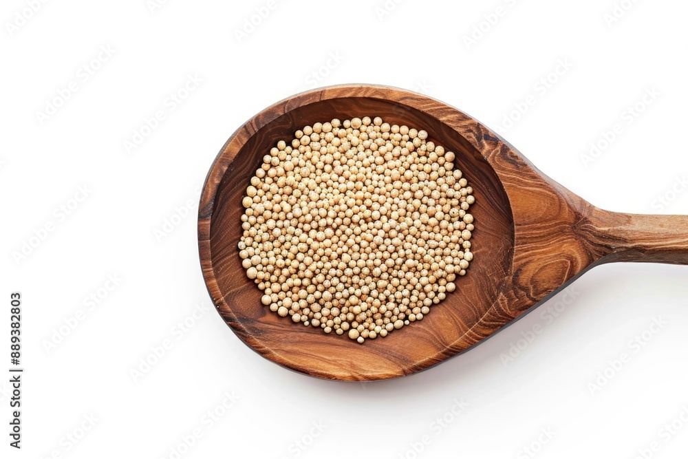 A wooden spoon filled with grains on a white surface A wooden spoon filled with grains on a white surface