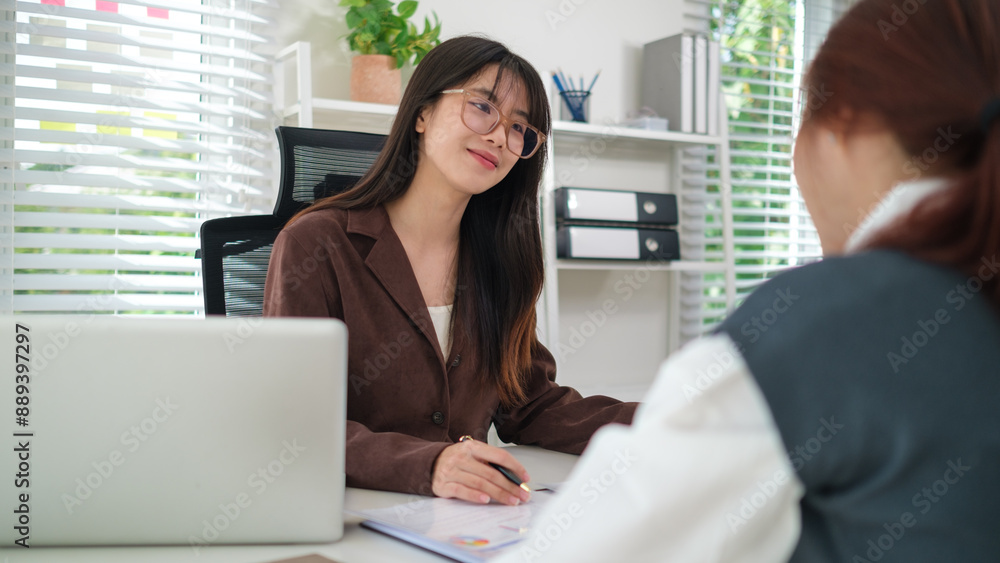 Two business women discussing business data with computer laptop at modern office. Two business women discussing business data with computer laptop at modern office.