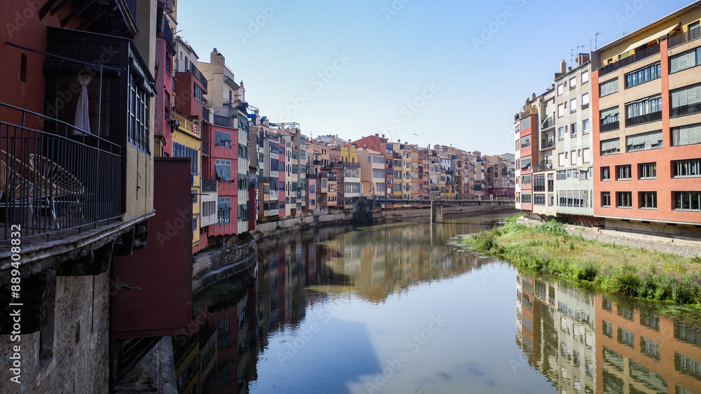 Girona, Spain - 18 July, 2024: Colorful buildings along the River Onyar, Girona, Catalonia Girona, Spain - 18 July, 2024: Colorful buildings along the River Onyar, Girona, Catalonia