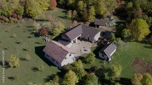 Aerial view of rural countryside with farm, house, and meadow, Gornja Ploca, Lika-Senj, Croatia. photo