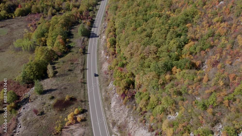Aerial view of winding road with traffic and autumn trees, Lika-Senj, Croatia. Aerial view of winding road with traffic and autumn trees, Lika-Senj, Croatia.
