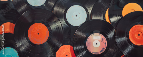 Overhead top down view of a collection of different vinyl records displayed in a vintage record store setting. The album covers feature various genres and eras, creating a nostalgic and eclectic photo