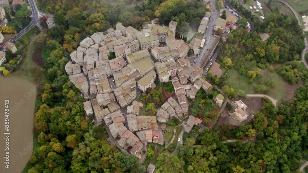 Aerial view of ancient village with Roman church in moody autumn clouds, San Casciano dei Bagni, Tuscany, Italy. Aerial view of ancient village with Roman church in moody autumn clouds, San Casciano dei Bagni, Tuscany, Italy.
