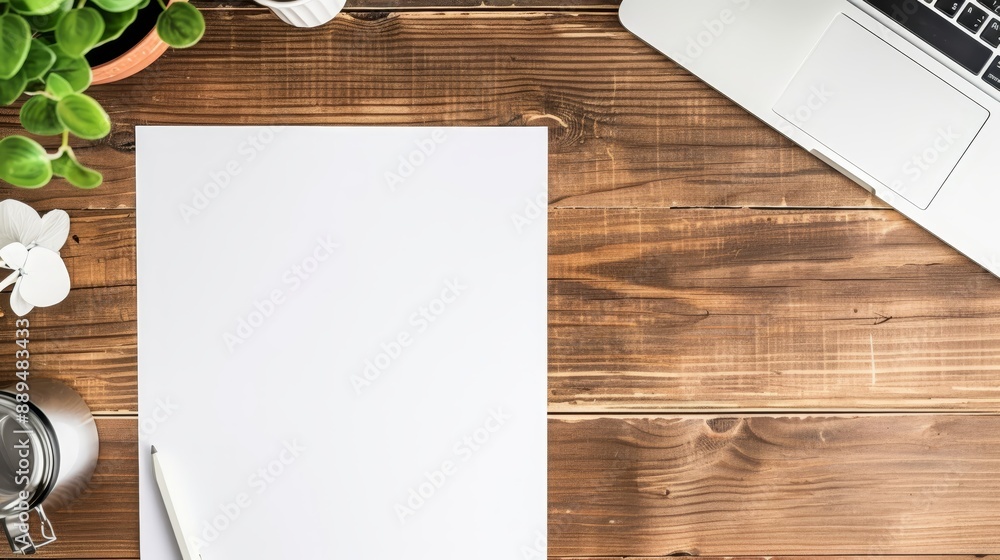Top view of a blank white paper on a rustic wooden desk, with a pen, a plant, and a laptop. Perfect for business or creative projects. Top view of a blank white paper on a rustic wooden desk, with a pen, a plant, and a laptop. Perfect for business or creative projects.