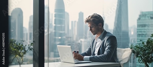 Focused Businessman Working on Laptop in Modern Office