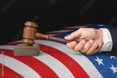 Judge's wooden gavel and USA flag photo