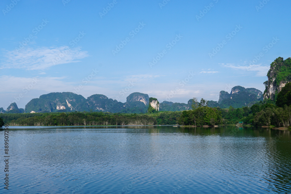 Beautiful clear sky at the swamp. Steam floats on the surface of the water with the reflection of the forest. Landscape with the image of lake Nong Thale, Krabi, Thailand. natural background. Beautiful clear sky at the swamp. Steam floats on the surface of the water with the reflection of the forest. Landscape with the image of lake Nong Thale, Krabi, Thailand. natural background.