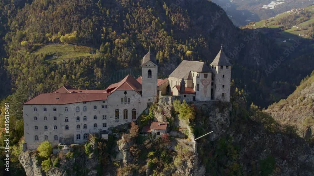 Aerial view of Monastero di Sabiona monastery with dolomites mountain peaks in autumn, Chiusa, South Tyrol, Italy. Aerial view of Monastero di Sabiona monastery with dolomites mountain peaks in autumn, Chiusa, South Tyrol, Italy.