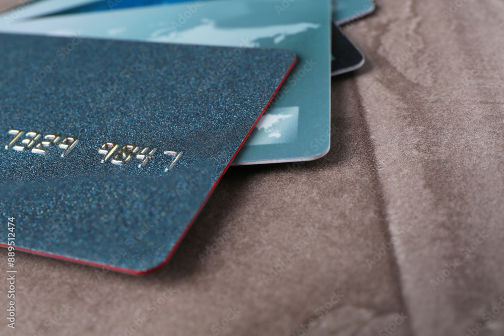 Credit cards on grey textured table, closeup. Space for text Credit cards on grey textured table, closeup. Space for text