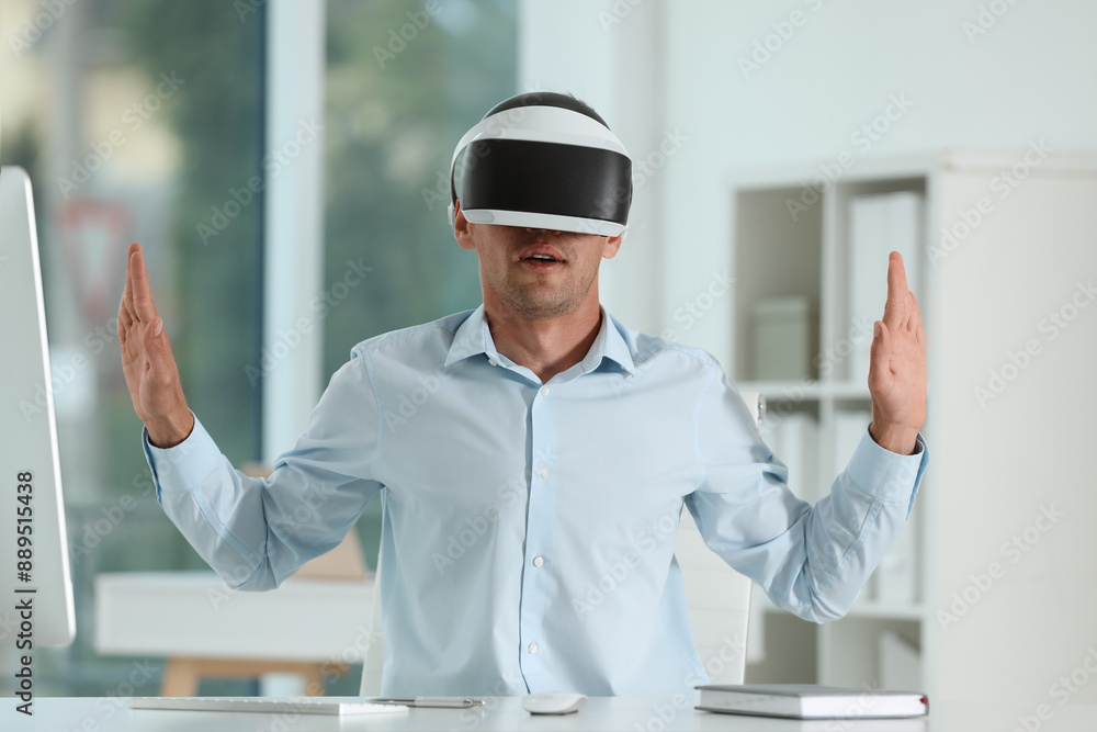 Man using virtual reality headset in office Man using virtual reality headset in office