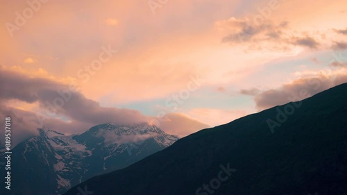 Wallpaper Mural 4K shot of orange clouds above the snowy Himalayan mountain peak of the Lahaul Valley as seen from Keylong in Himachal Pradesh, India during the sunset. Beautiful dramatic sky during the sunset. Torontodigital.ca