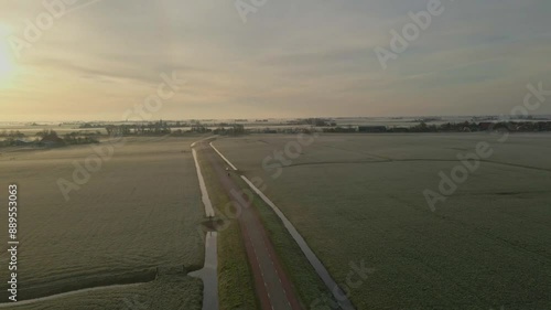 Aerial view of foggy sunrise over meadows and fields in Exmorra, Friesland, Netherlands. photo