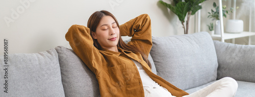 Fotografie Young woman enjoying mind free moment relax and calm on the sofa at home