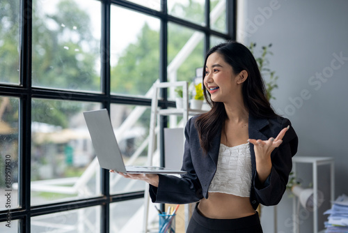 Free Download A woman is holding a laptop and smiling - GFXLoad