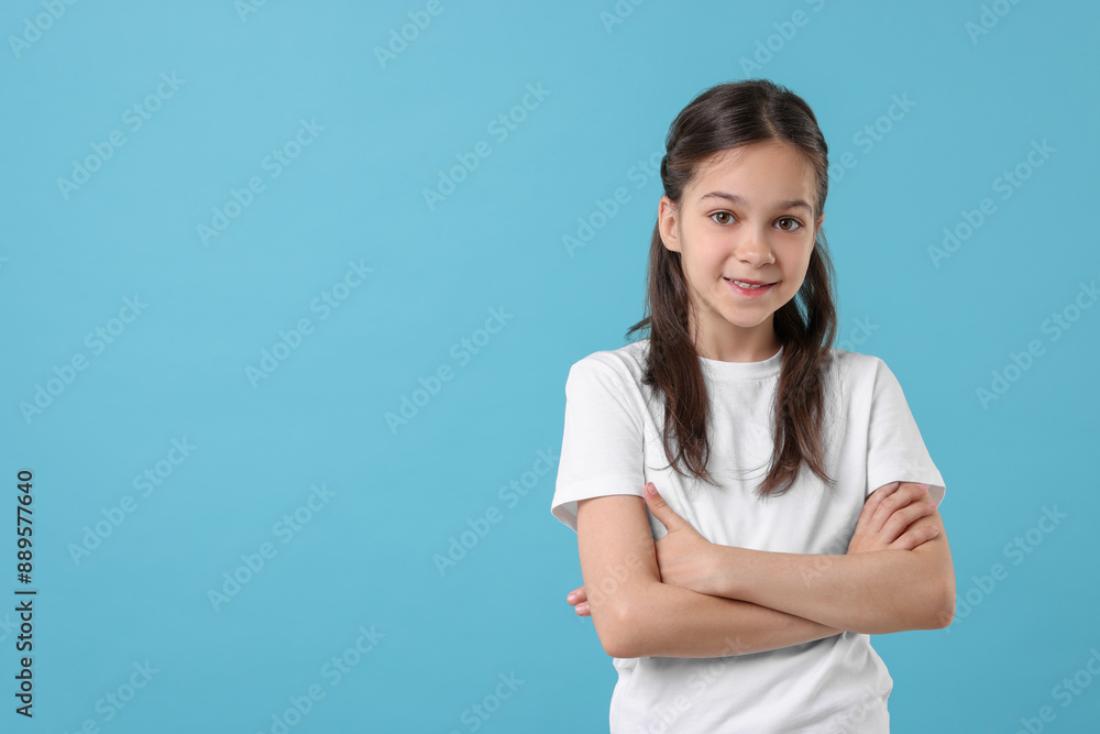 Portrait of beautiful girl on light blue background, space for text Portrait of beautiful girl on light blue background, space for text