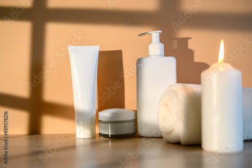 Wallpaper Mural White containers, white towel and burning candle. On a beige background. Torontodigital.ca