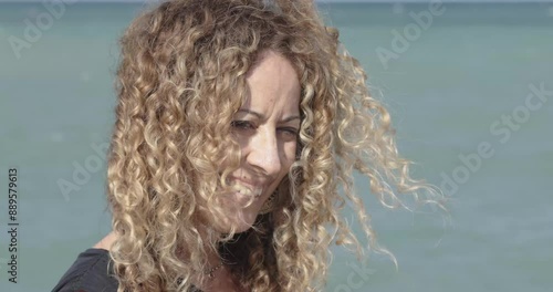 Smiling middle age woman by the sea
