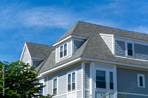 Beautiful family home facade with steep roof and dormer windows in Brighton, Massachusetts, USA photo