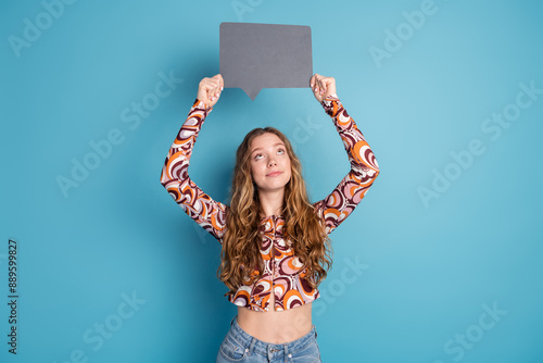 Photo of nice young girl look empty space mind bubble wear top isolated on blue color background