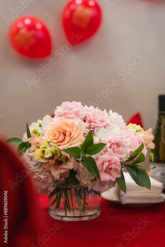 A bouquet of pastel flowers for summer sits in the middle of a table at a Chinese restaurant.