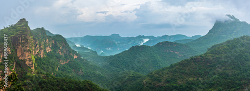 Panoramic view of Pachmarhi valley having clouds and mist shrouded hills rolling on each other from vantage point Priyadarshini Point in Pachmarchi, Madhya Pradesh, India. photo