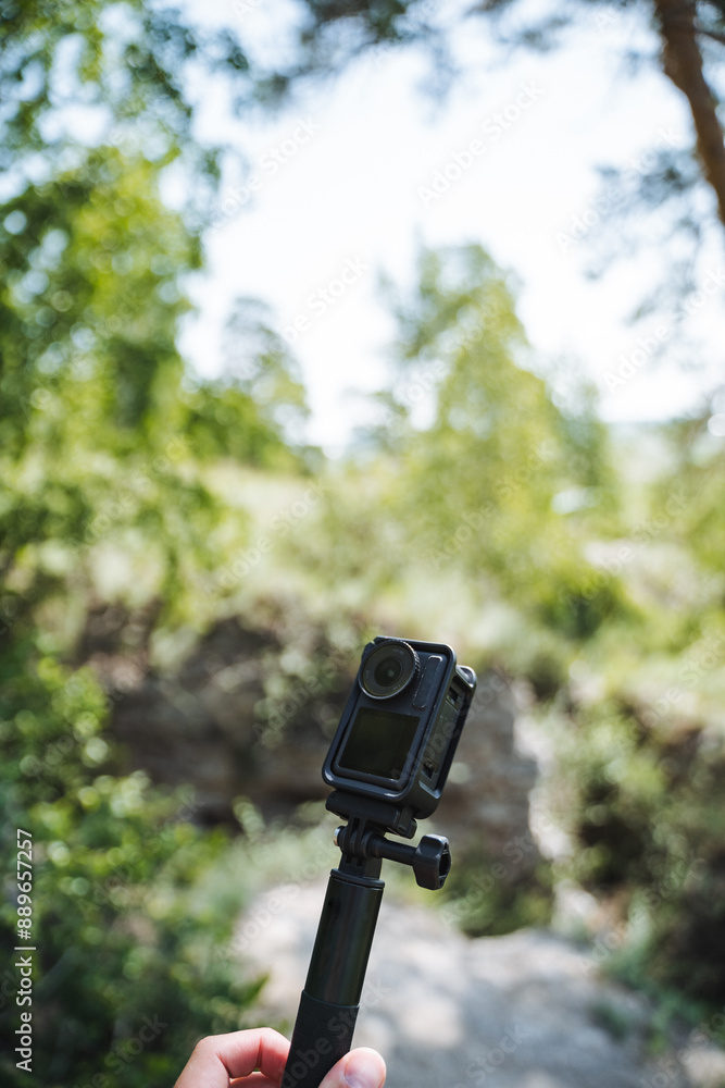A person is calmly taking pictures in a serene natural environment with a camera securely placed on a tripod. The beautiful scenery consists of trees, grass, and lovely views A person is calmly taking pictures in a serene natural environment with a camera securely placed on a tripod. The beautiful scenery consists of trees, grass, and lovely views