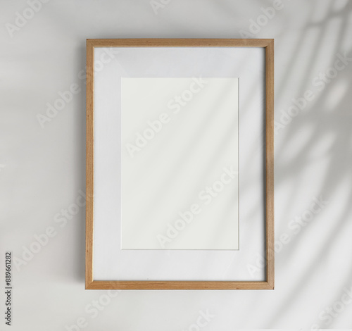 Wooden photo frame A4 size with White Photo Mat, vertical artwork on a white wall, front view
