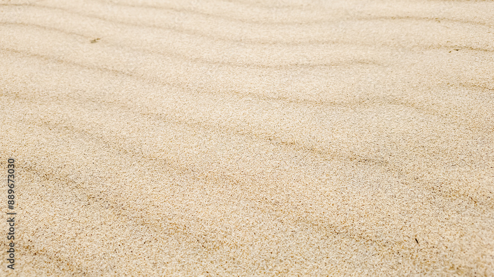 Close-up of pristine raked sand with wavy patterns, evoking serenity and tranquility, concept of zen garden or mindfulness Close-up of pristine raked sand with wavy patterns, evoking serenity and tranquility, concept of zen garden or mindfulness