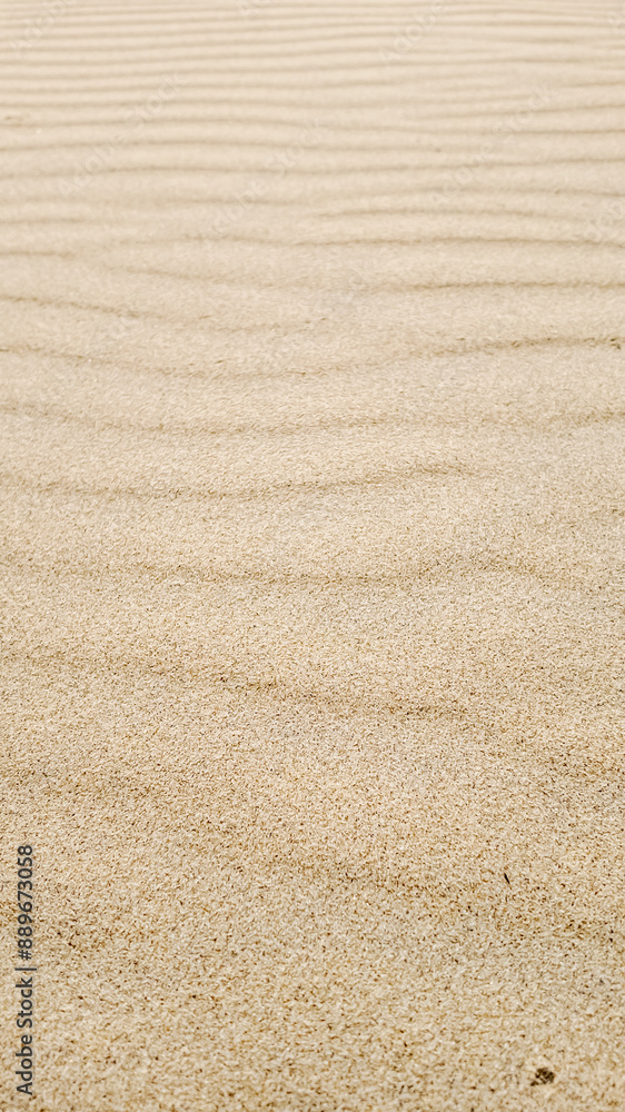 Sandy beach ripples at low tide evoke summer vacation and tranquility Sandy beach ripples at low tide evoke summer vacation and tranquility