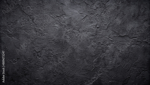 Dark black concrete texture with a natural pattern for display or product montage on a copy space image.