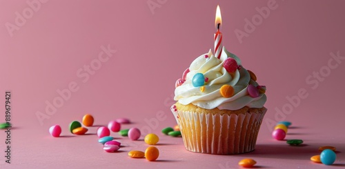 Single Birthday Cupcake With Candle and Sprinkles on Pink Background