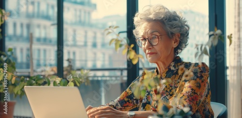 Senior Woman Working on Laptop at a Cafe