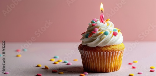 Single Birthday Cupcake With Candle and Sprinkles on Pink Background