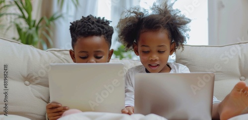 Two Children Watching Laptop on Couch in Living Room