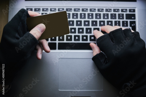 Typing, credit card and hands of hacker for cyber crime, financial fraud and cloning for identity theft or breach. Person, dark and online for hacking or malware attack, phishing and account takeover