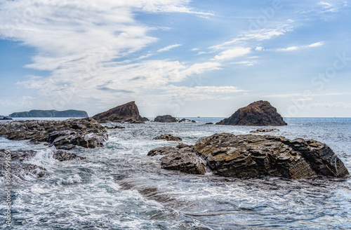 Dramatic rock formations on the coast of Pacific Ocean in Nachikatsuura, Wakayama, Japan, part of the Yoshino-Kumano National Park and Nanki Kumano geopark. photo