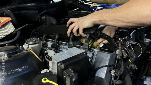 Auto mechanic working in garage. Repair service.