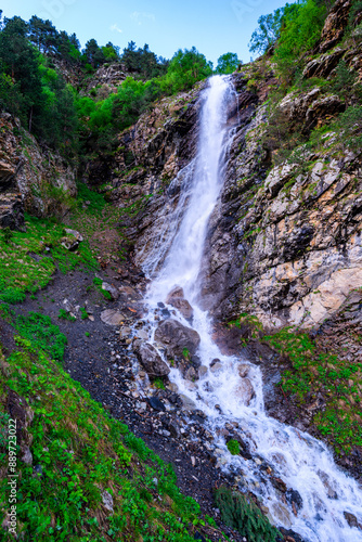 A stormy waterfall falling from a stone cliff. The North Caucasus. Russia