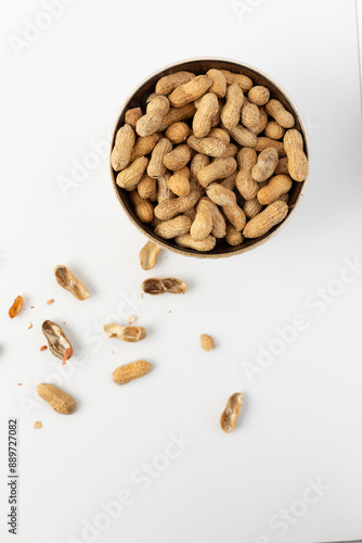 Top View of a Bowl of Dry Roasted Peanuts on White Background