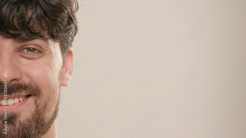 Obraz premium Young adult man looking at camera smiling, isolated on white background, close up shot. Natural beauty skin care concept.