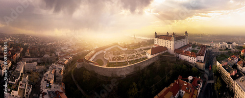 Epic Beautiful Bratislava cityscape, Bratislava castle in the morning mist and clouds during the sunrise in warm colors with Danube river behind, great composition