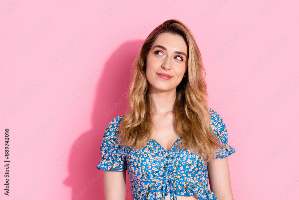 Photo portrait of pretty young girl look interested empty space wear trendy blue flower print outfit isolated on pink color background Photo portrait of pretty young girl look interested empty space wear trendy blue flower print outfit isolated on pink color background