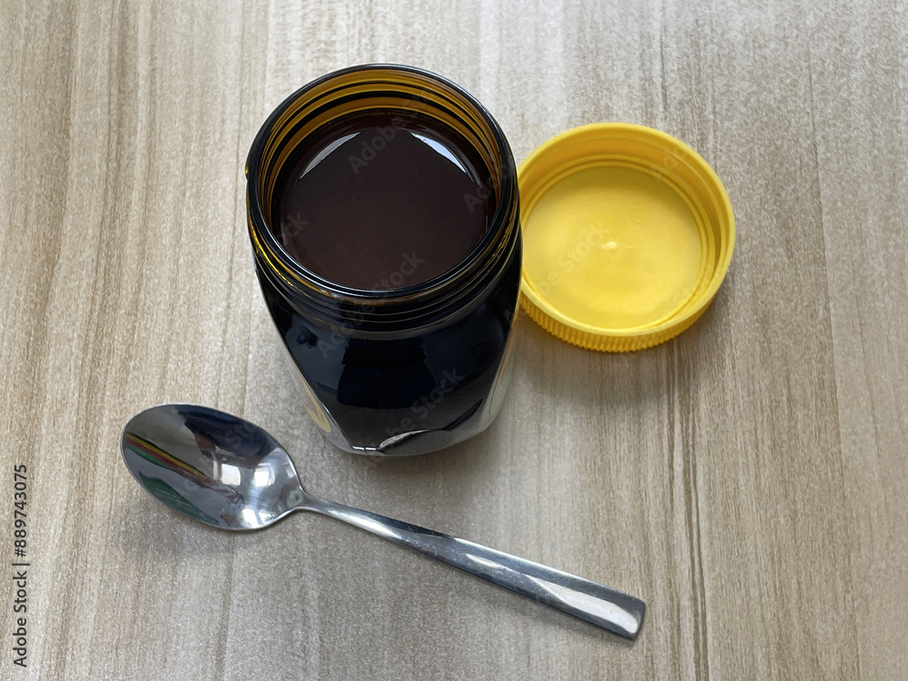Open jar of yeast extract spread on kitchen table