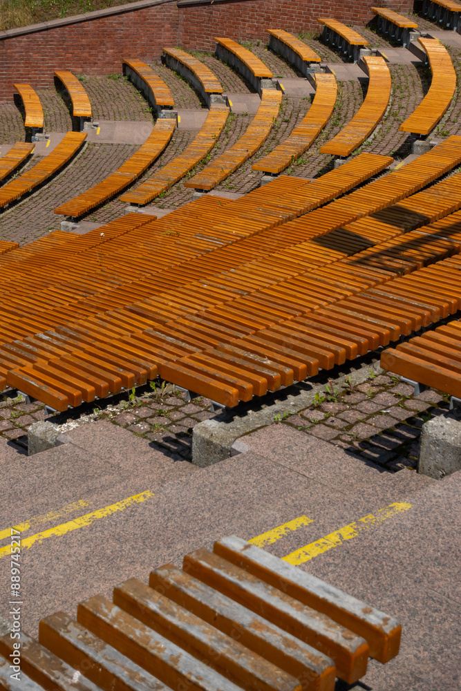 Brown wooden benches in the city amphitheater. Close up of the rungs. Urban public spaces in the service of culture