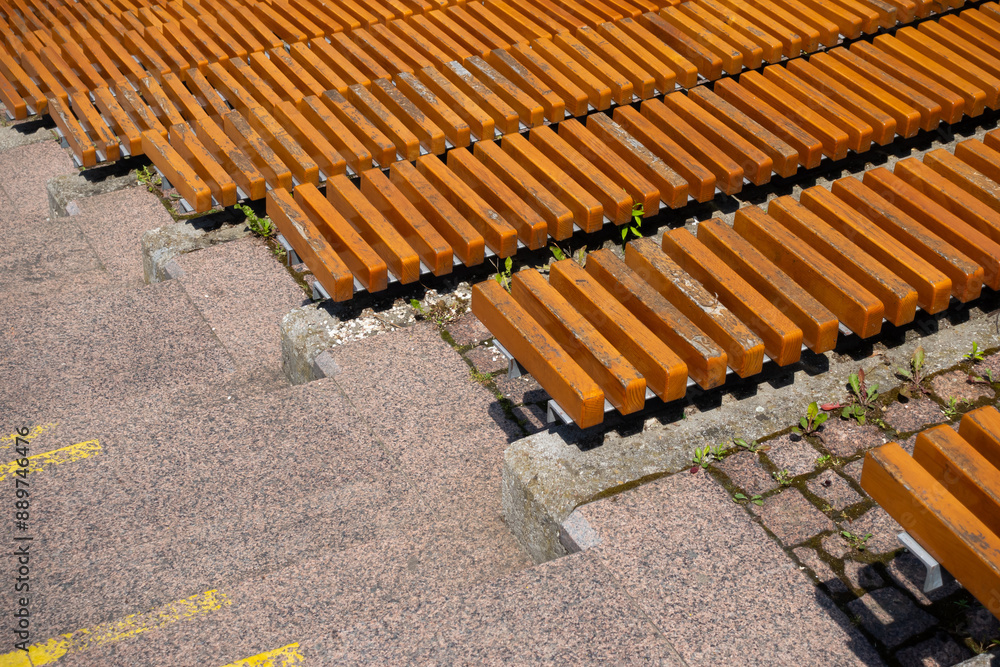 Brown wooden benches in the city amphitheater. Close up of the rungs. Urban public spaces in the service of culture
