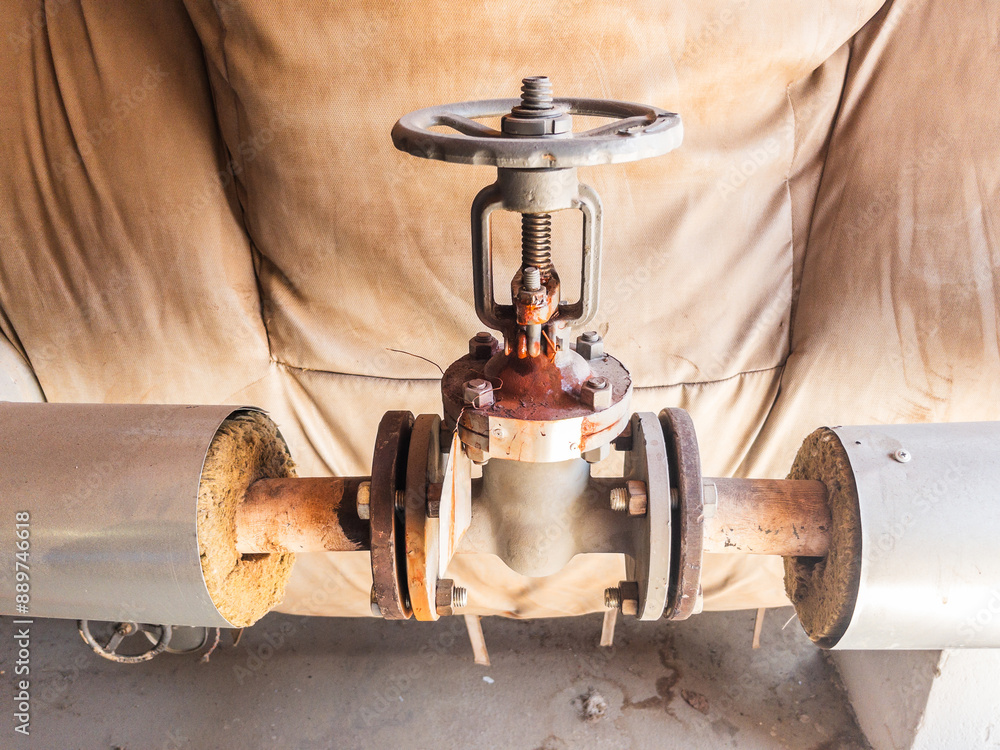 Old grey rusty pipeline valve close up