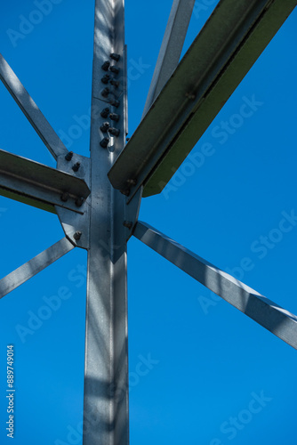 Obraz na płótnie Bolted connections of steel elements of the observation tower. Construction details of galvanized steel against a blue sky background. w salonie