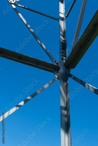 Bolted connections of steel elements of the observation tower. Construction details of galvanized steel against a blue sky background.