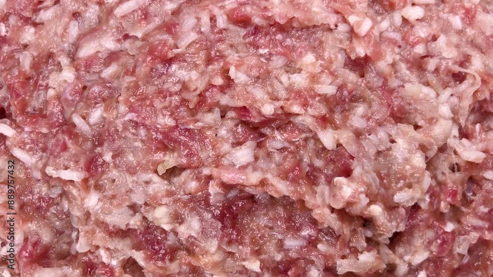 A detailed close-up of a ground meat and rice mixture, commonly used as filling for traditional cabbage rolls. The image highlights the texture and blend of ingredients, essential for the dish. A detailed close-up of a ground meat and rice mixture, commonly used as filling for traditional cabbage rolls. The image highlights the texture and blend of ingredients, essential for the dish.