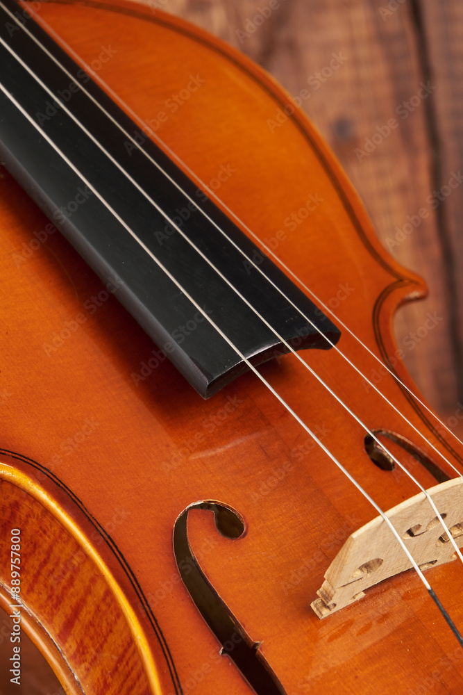 Delicate and stylized violin resting on a rustic wooden background Delicate and stylized violin resting on a rustic wooden background